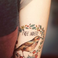 Tattoo colored bird on hand