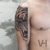 Tattoo painted by Valentin Hirsch on shoulder of tiger face