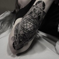 Tattoo painted in dot style of various geometrical ornaments on arm
