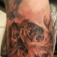 Tattoo of realistic human skull on arm