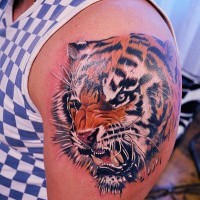 Realistic tiger head on shoulder tattoo