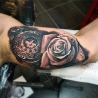 Tender realistic rose with dew drop and ancient watch tattoo on biceps