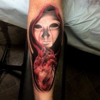 Terrifying colored forearm tattoo of creepy woman with human heart