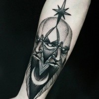 Terrifying looking black ink forearm tattoo of demonic face by Michele Zingales