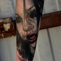 Terrifying looking colored arm tattoo of bloody vampire woman