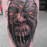 Terrifying looking colored leg tattoo of stunning monster face