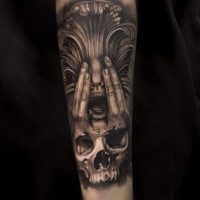 Terrifying looking detailed arm tattoo of interesting face with human skull