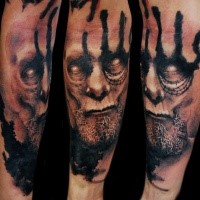 Terrifying looking forearm tattoo of demonic face with beard