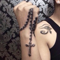 Tatuaje de rosario precioso en la mano y  ojo de Horus simple en el hombro