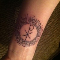 Thin black ink Chi Rho special Christ monogram religious forearm tattoo in glowing circle