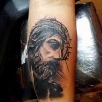 Thoughtful Jesus Christ in crown of thorns religious forearm tattoo