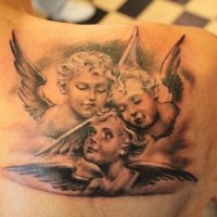 Three cherubs tattoo on shoulder blade