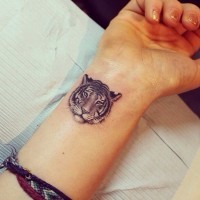 Tiger face tattoo on wrist