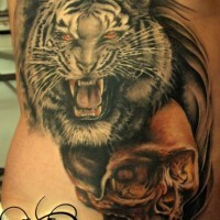 Tiger head and spooky skull tattoo on ribs