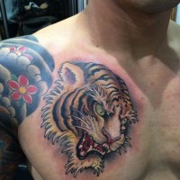 Tiger head tattoo on chest in asian style by Ami James