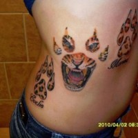 Tiger paws and head tattoo on side