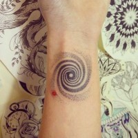 Tiny black ink ankle tattoo of hypnotic ornament