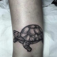 Tiny black ink funny turtle tattoo on arm muscle