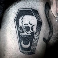 Tiny black ink little wooden coffin with skull tattoo on shoulder