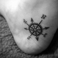 Tiny black ink nautical compass tattoo on foot