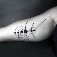 Tiny black ink solar system tattoo on arm