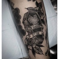Tiny black ink wooden coffin tattoo stylized with rabbit and lettering