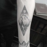Tiny black ink zodiac symbol tattoo on forearm stylized with night sky and forest