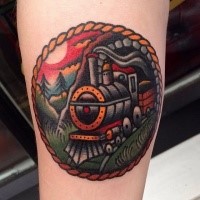 Tiny circle shaped tattoo of steam train portrait