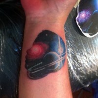 Tiny colored deep space tattoo on wrist