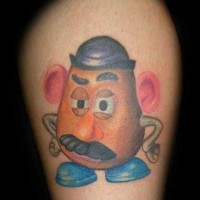 Tiny colored funny cartoon hero tattoo on leg