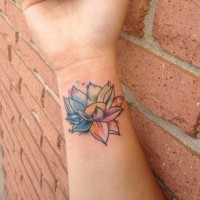 Tiny homemade like watercolor flower tattoo on wrist