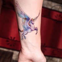 Tiny multicolored wrist tattoo of fantasy Pegasus