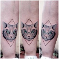 Tiny mystical painted cat face tattoo with blue eyes and geometrical figure