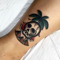 Tiny old school palm tree with skull and pyramids tattoo on ankle