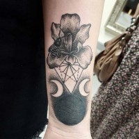 Tiny strange combined black ink cult forearm tattoo of flower with bee and dark planet with moons