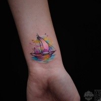 Tiny watercolor style wrist tattoo of small sailing ship
