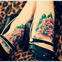 Traditional colored and painted little roses tattoo on feet