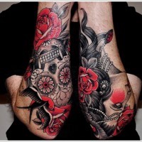Traditional Mexican style painted flowers with skull tattoo on arms