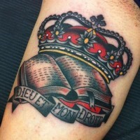 Traditional style crown tattoo with script