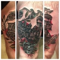 Train memorial colored thigh tattoo of steam train with lettering