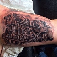 Train tattoo painted in black and gray style on biceps