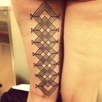 Tribal style big black ink mystical patterns tattoo on thigh