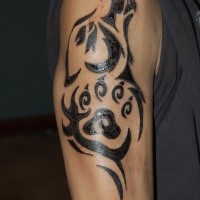 Tribal style black ink shoulder tattoo of wolf
