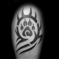 Tribal style black ink shoulder tattoo of cool picture with animal paw print