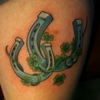 Two horseshoes and clover for luck tattoo