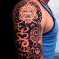 Typical black and white shoulder tattoo of various ornaments