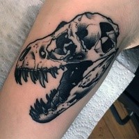 Typical black ink arm tattoo of dinosaur skull