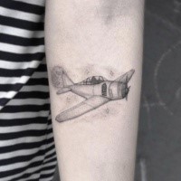 Typical black ink arm tattoo of flying plane with stars