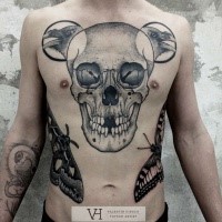 Typical black ink chest tattoo of human skull with crows