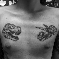 Typical black ink chest tattoo of various dinosaur skulls